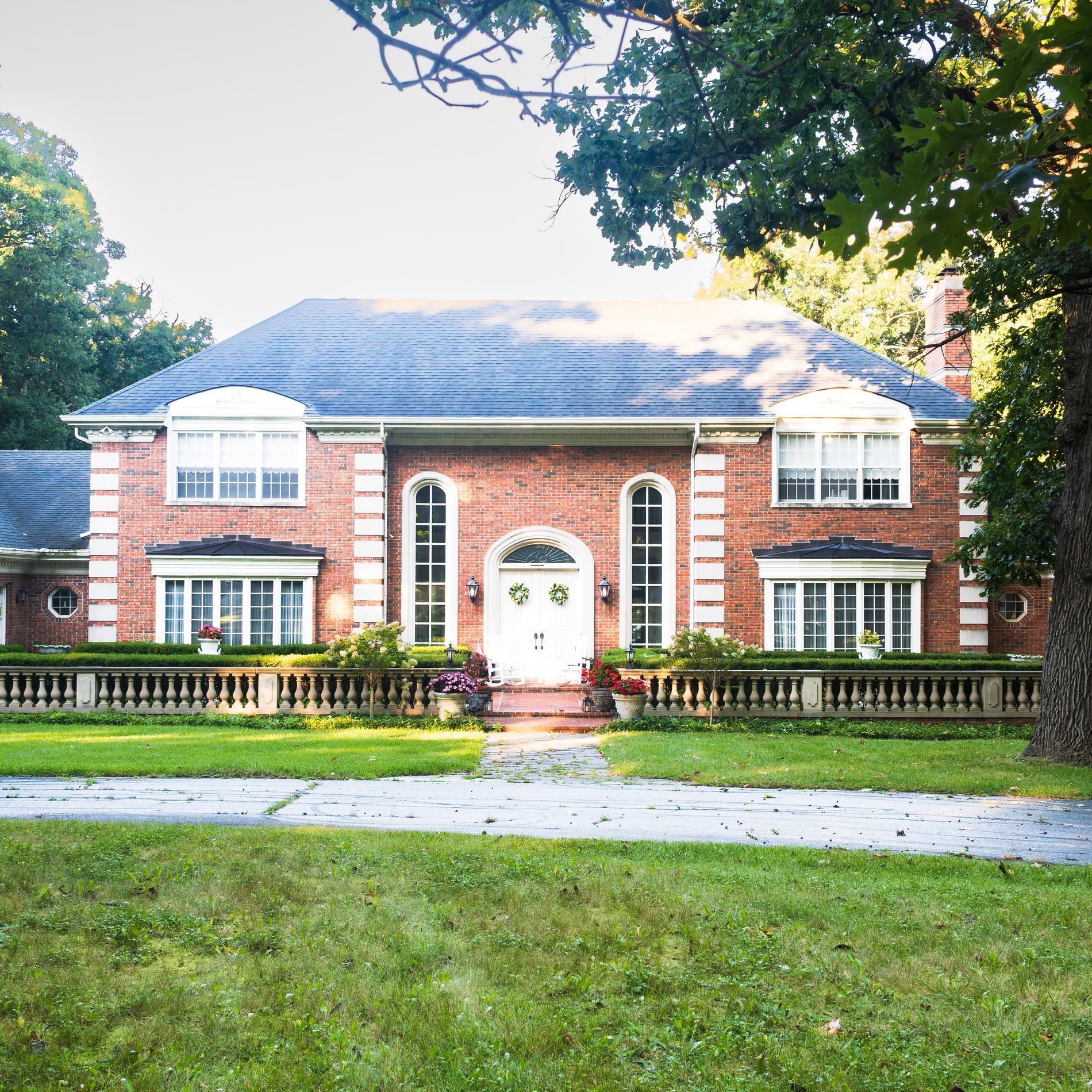 The Raven Ridge mansion: red brick Georgian facade with white trim