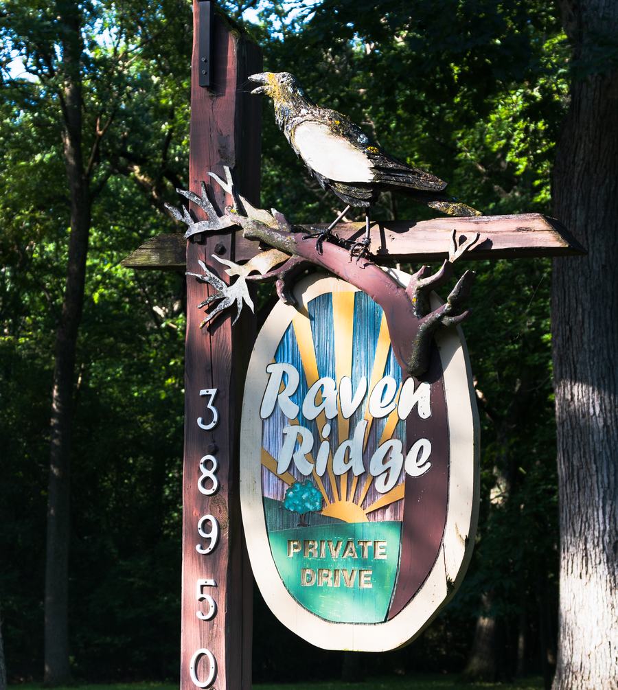 The hand-painted Raven Ridge sign with a raven above it