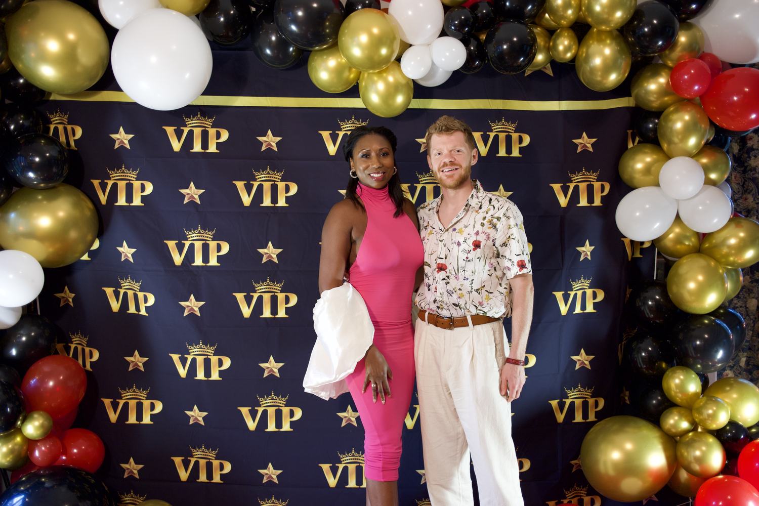 Two guests arriving at an evening event at the estate